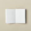 A6 mini softcover pocket notebook inside blank pages lays flat desk