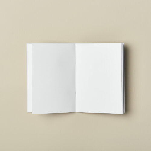 A6 mini softcover pocket notebook inside blank pages lays flat desk