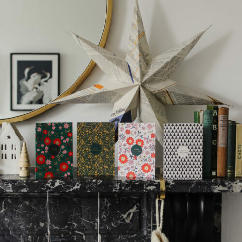 Christmas cards along the christmas mantlepiece modern scandi decor paper decorations and star