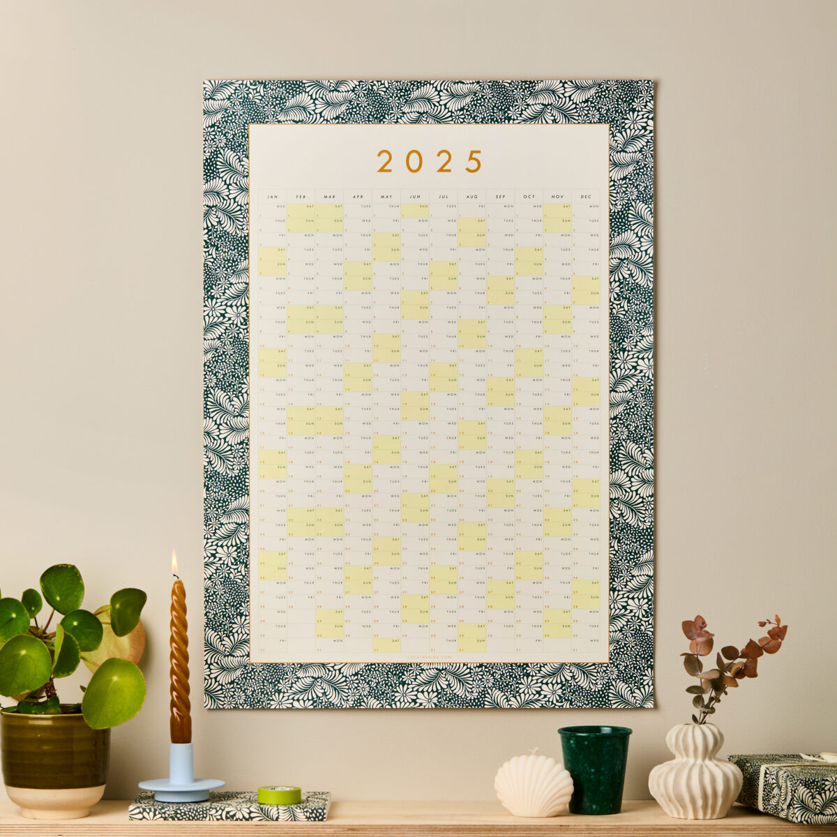 styled image of a dark green bordered decorative floral wall planner