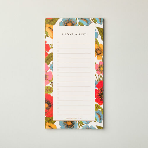 overhead image of the garden bloom floral list notepad, showing the lined pages, checkboxes and beautiful brightly coloured hand drawn floral border. Perfect stocking filler or secret santa gift for flower lovers under £10