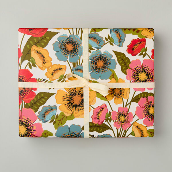 Luxury floral patterned wrapping paper perfect for artists and garden lovers. The design is a bold floral made up of poppy like flowers in red, pink, blue and yellow