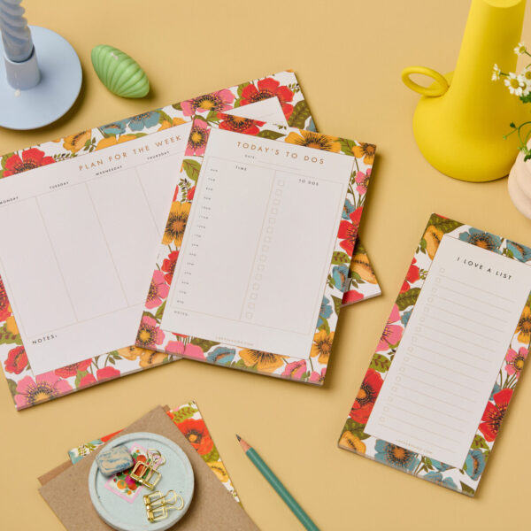 Bloom floral stationery collection of week planner, day planner plus checklist notepad. The design is made up of Poppy like flowers in red, pink, yellow and blue. Stationery items are styled on Hay Farrow and ball background