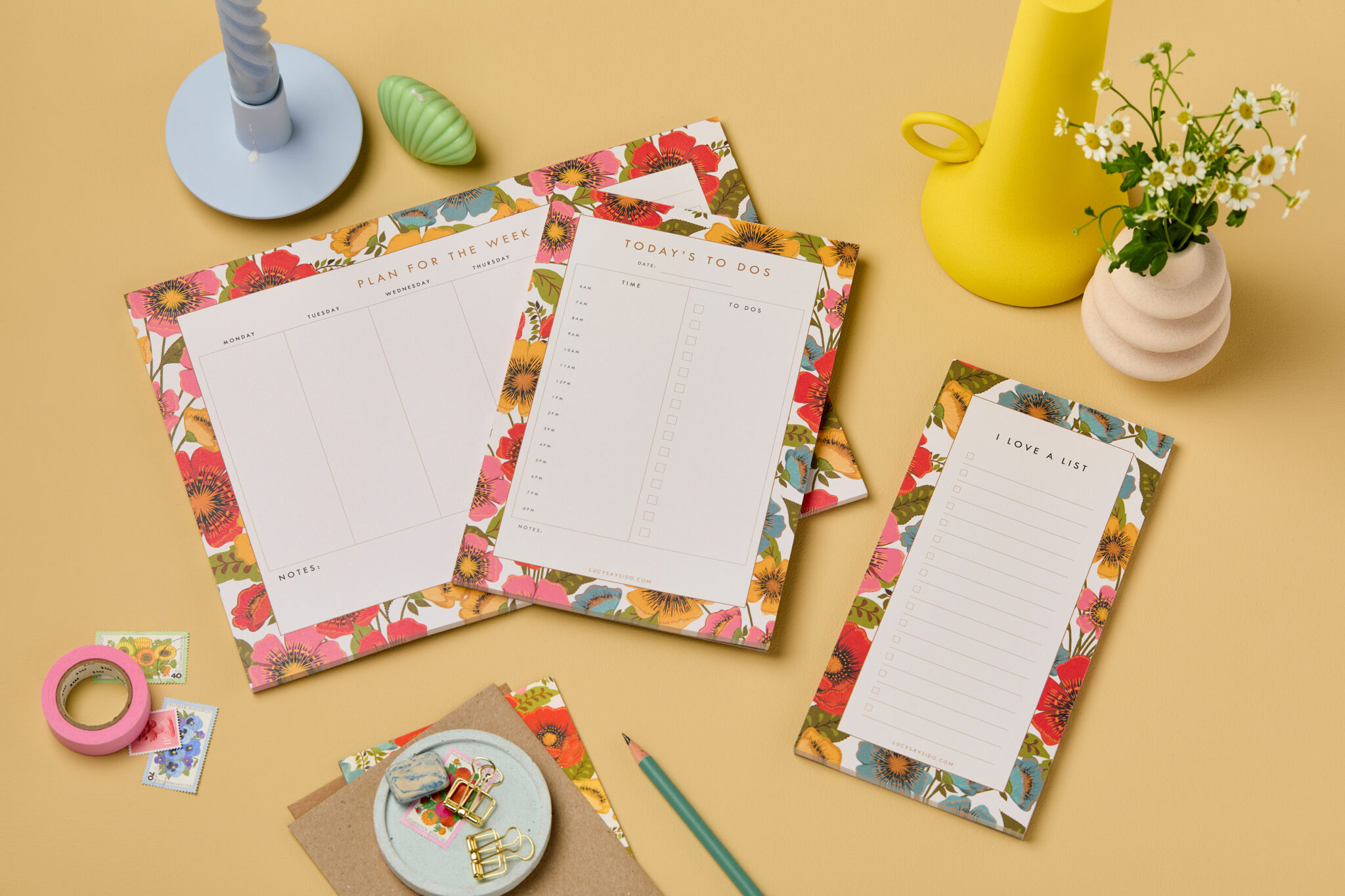 Bloom floral stationery collection of week planner, day planner plus checklist notepad. The design is made up of Poppy like flowers in red, pink, yellow and blue. Stationery items are styled on Hay Farrow and ball background