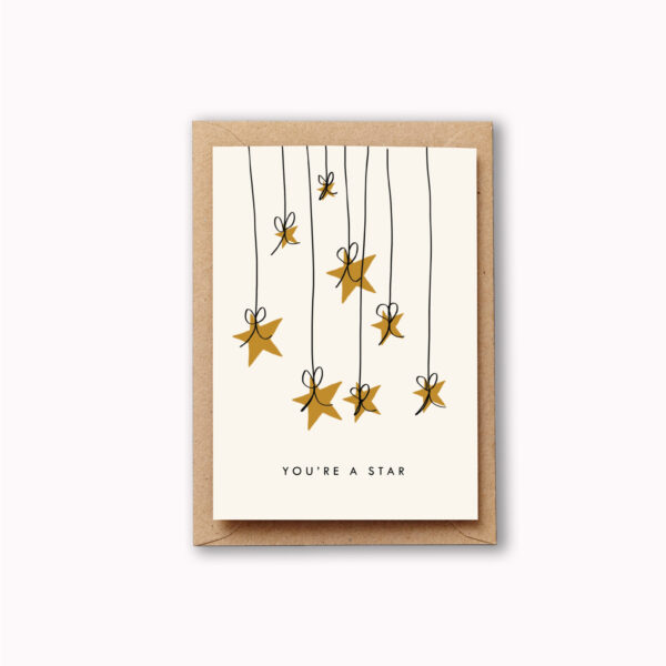 golden stars dangle from threads tied with bows from the top of the card and underneath reads 'you are a star'. Perfect for saying thank you to someone exceptional.